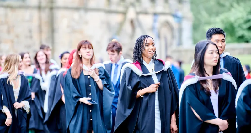 Graduates in robes exiting Durham Cathedral