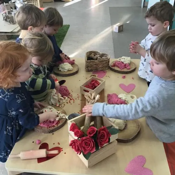 Children playing with valentines theme modelling dough