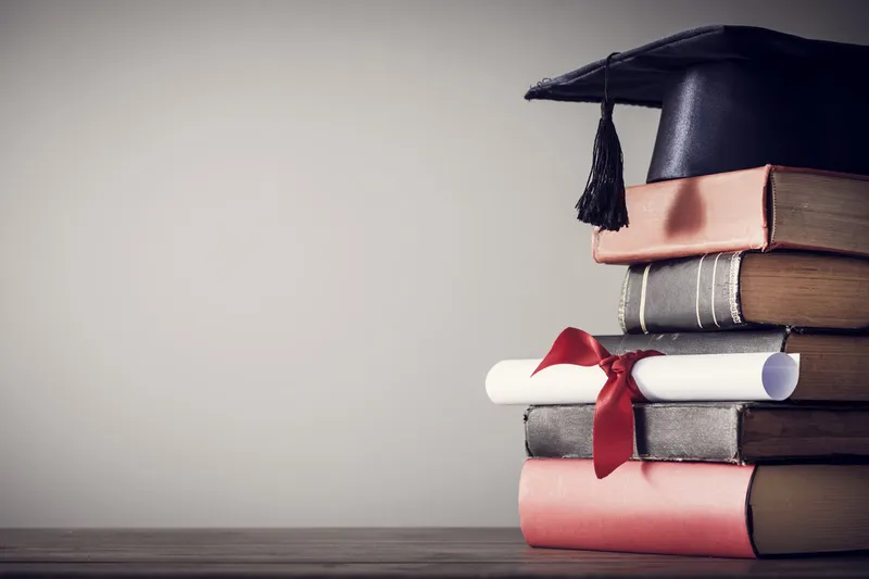 Mortarboard Hat on stack of books