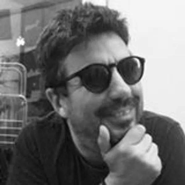 Black and white photograph of Associate Professor Fernando Dias, PhD wearing sunglasses and smiling
