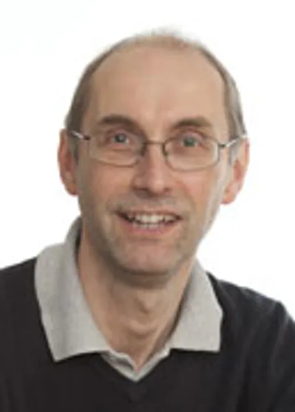 Headshot style photograph of Professor Andrew Beeby in front of a white background.