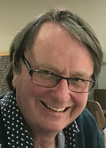 A close up photo of Professor Michael Petty, BSc PhD DSc FInstP FIET smiling