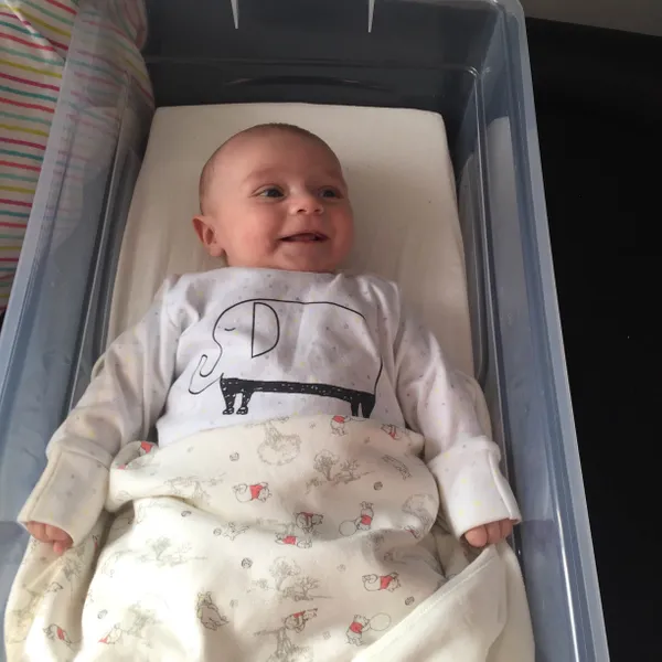 Baby lying in a transparent plastic box