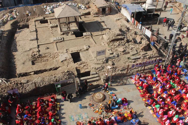 Puja being performed outside the excavated remainds of the Kasthamandap in Kathmandu