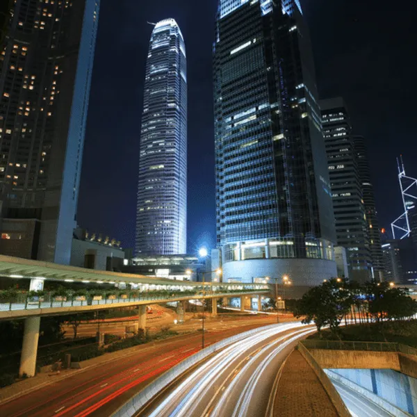 City skyline at night showing blurred car lights
