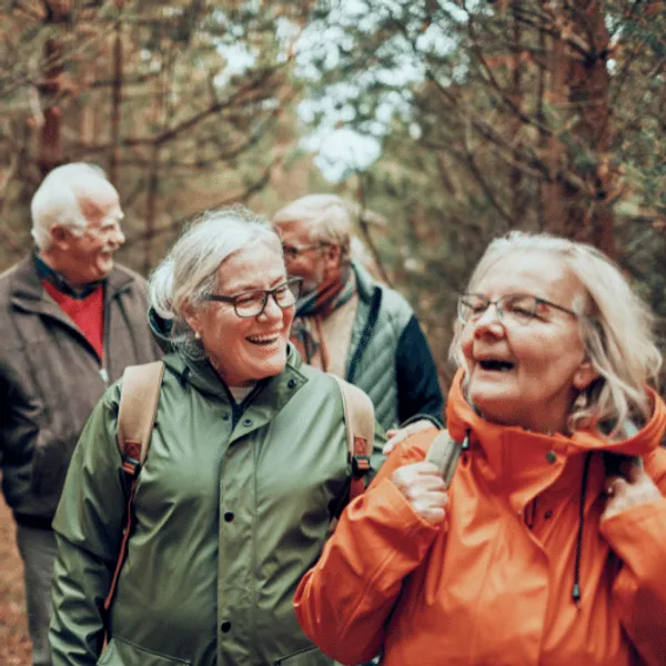 A group of older people walking in the woods