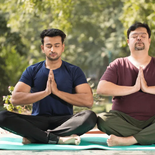 Two men meditating in the park