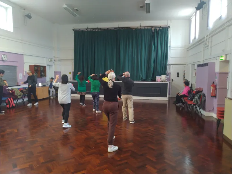 Adults doing exercise in a hall