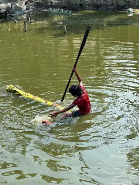 Person fishing in sinking boat in Bangladesh