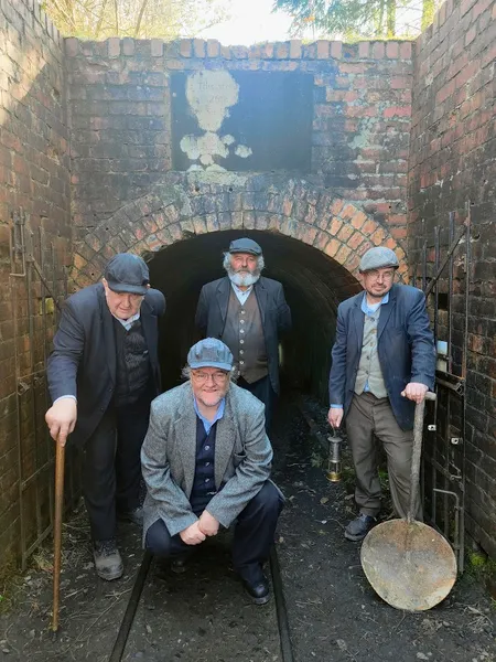 4 men in front of beamish mine entrance