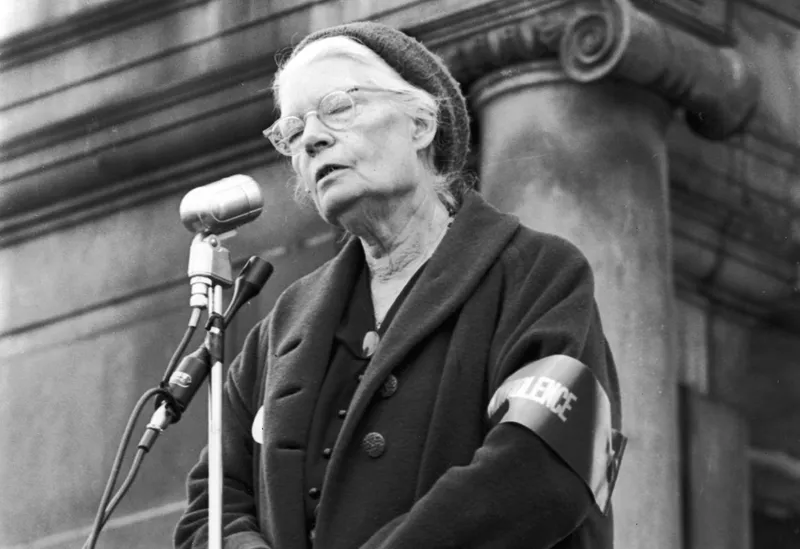 Dorothy Day in black and white photo speaking in a antiwar demonstration