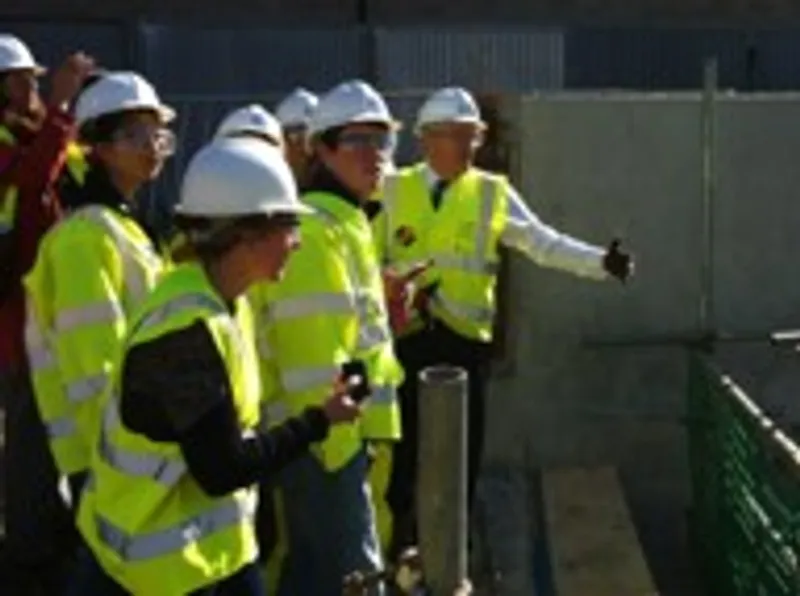People wearing hard hats at building site