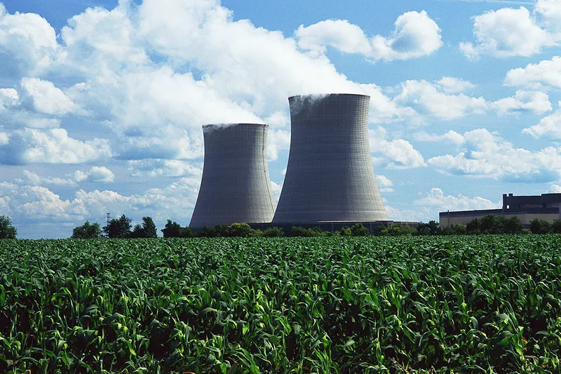 A nuclear power station with a field of crops in the foreground