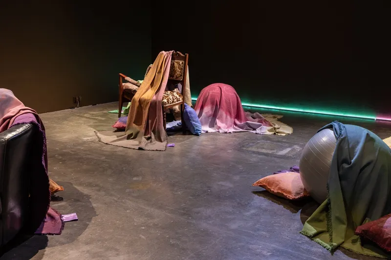 Lynne Kouassi & Nora Heidorn, Naturkulturpolitik, 2023, wax-painted and hand-dyed cotton, various support structures, satin care labels. Installation view in the group exhibition Being Horizontal, curated by Nora Heidorn at Project Arts Centre, Dublin. Photo: Ste Murray.