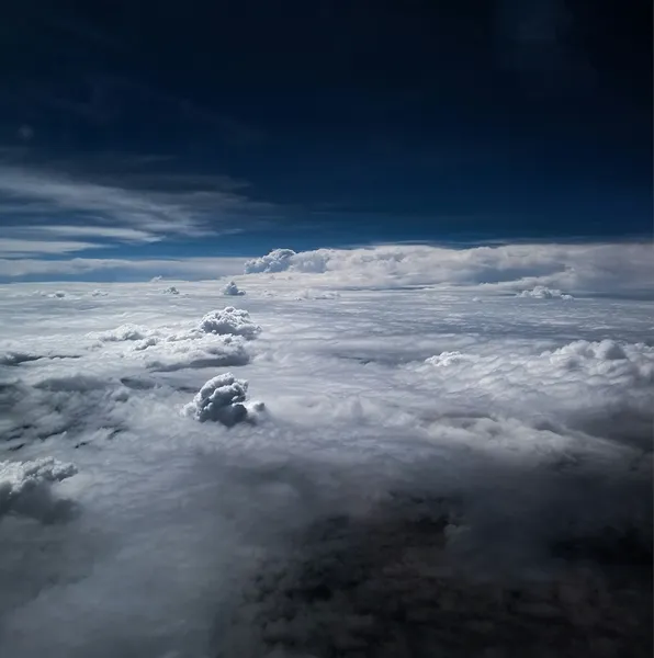 Clouds viewed from above against a dark sky
