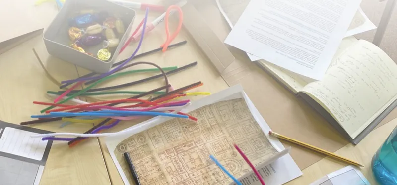 Table with pipe cleaners and papers