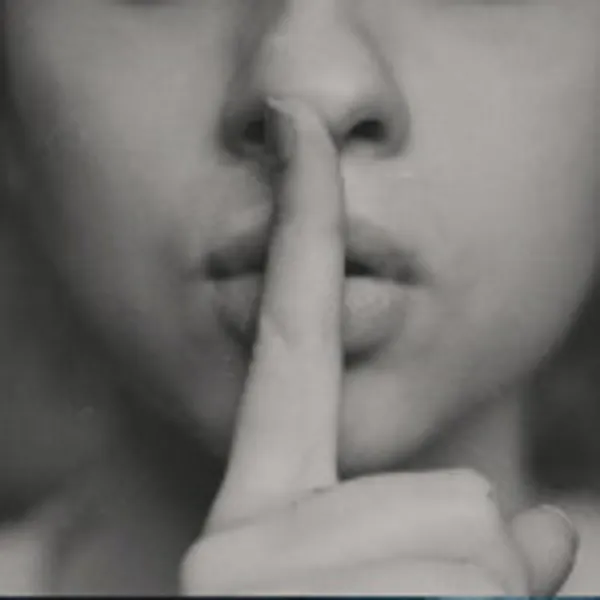 Face image with finger to lips