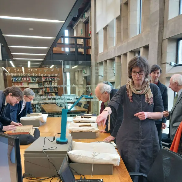 People inspecting at ancient texts