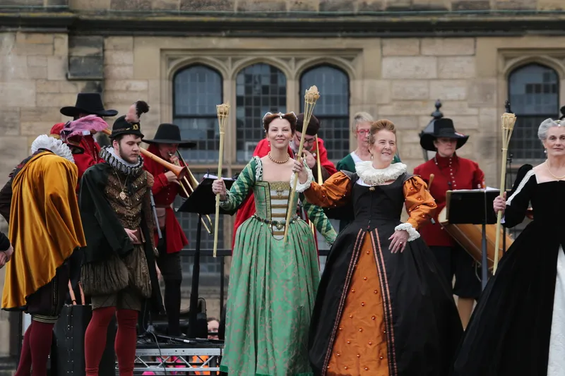 People dressed in medieval tudor costume at a re-enactment event