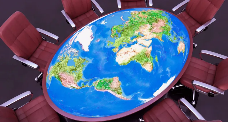 A table map of the world surrounded by empty chairs
