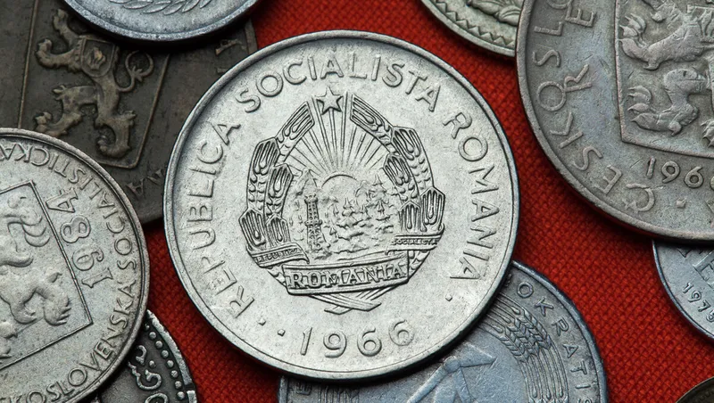A coin from Communist Romania surrounded by other Soviet-era coins