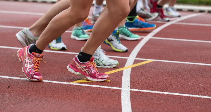 Close up of runners lower legs at a starting line