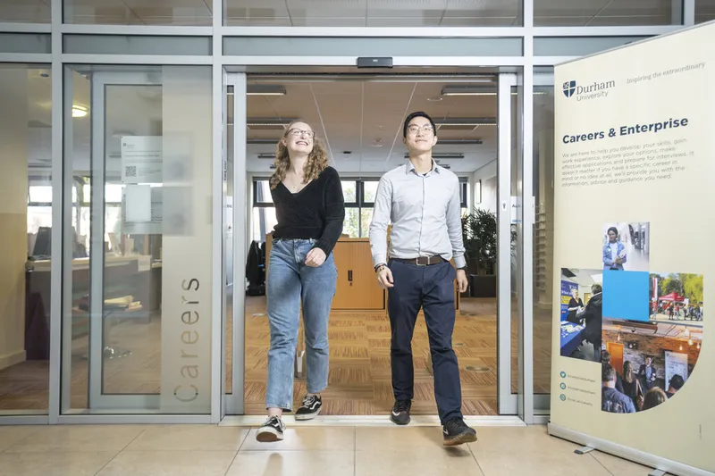 2 people walking out of the Careers & Enterprise Centre Smiling