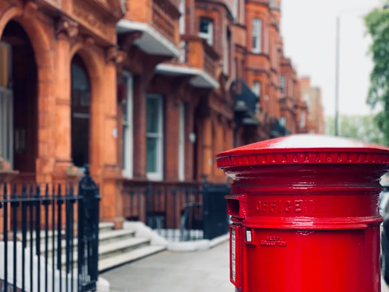 Post-box in front of red-brick terraced houses
