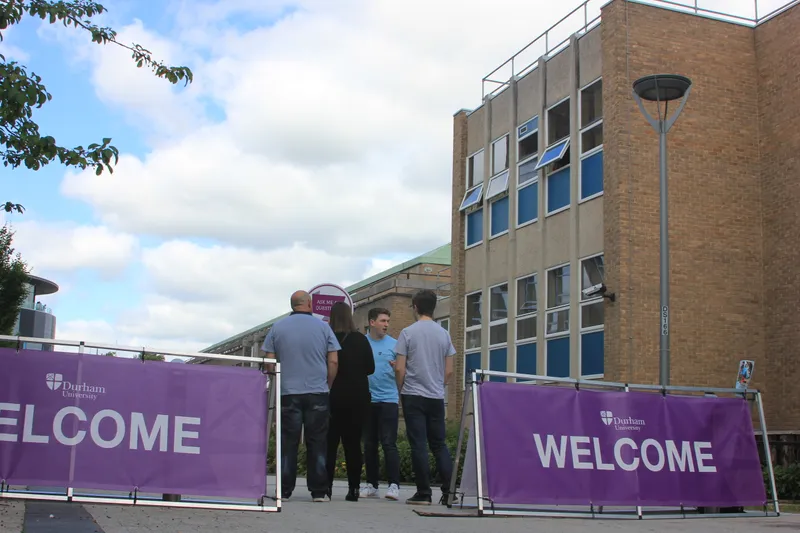 Open Day image with welcome banners and visitors looking at the Rochester Building