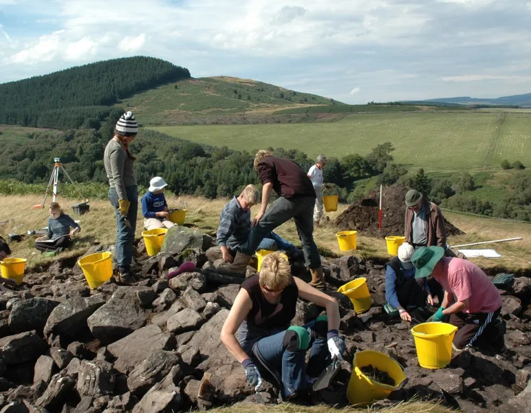 A coloured photograph showing students excavating.