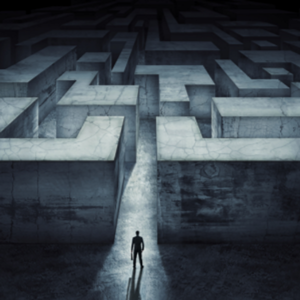 Man in front of concrete maze