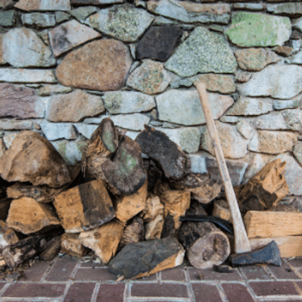 A pile of logs with an axe