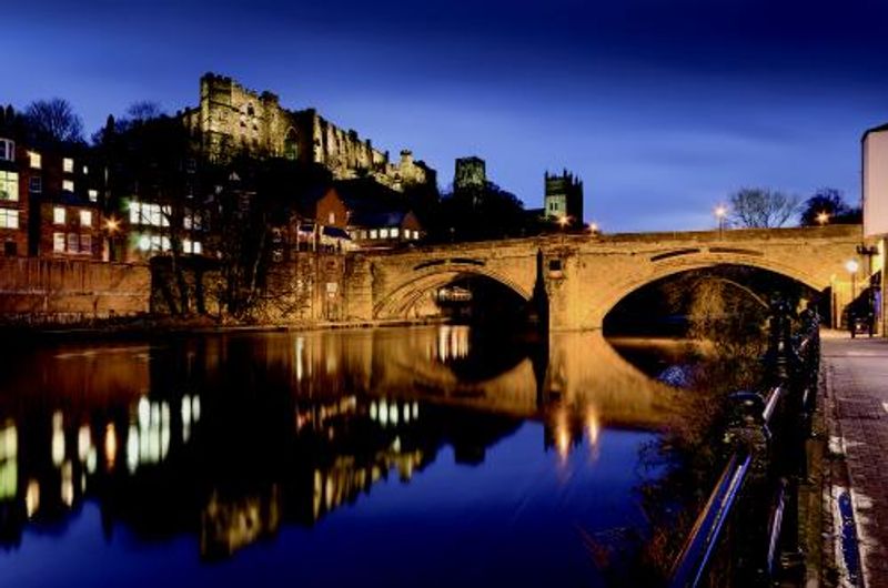 Framwellgate bridge, Durham Castle, and Durham Cathedral lit up at night