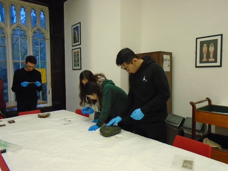 Community members taking part in a workshop exploring museum objects.