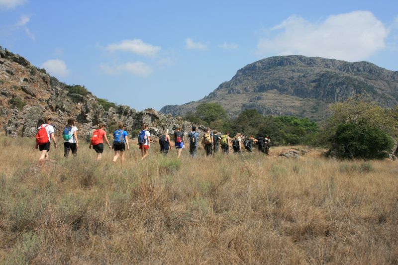 Students walking through grassland in South Africa