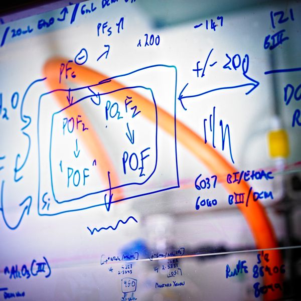 Scientific writing with red mark through it