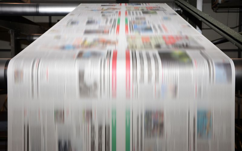 Printing press producing newspapers