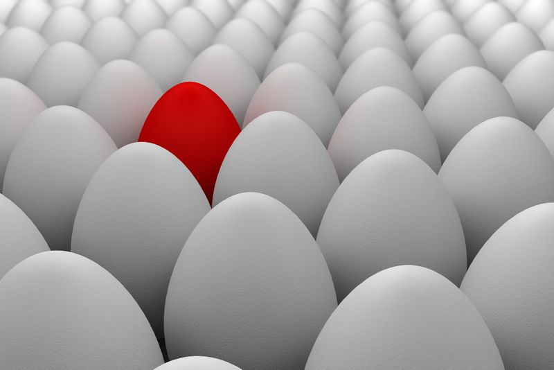 A red egg amongst white eggs