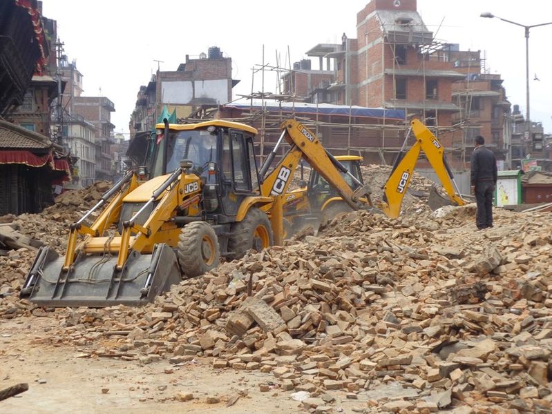 A bulldozer clearing away rubble from a heritage site after the 2015 Gorka Earthquake