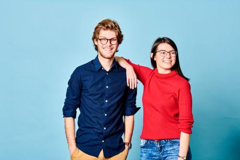 Two students on blue background