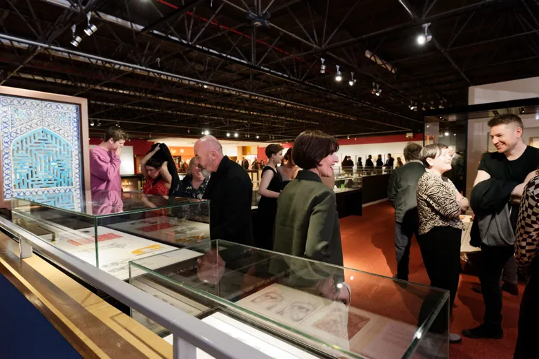Visitors to the exhibition exploring the display cabinets.