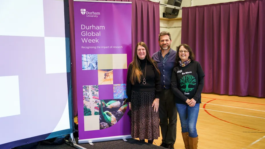 Durham University staff stand beside the Global Week banner during the Global Goals Summit