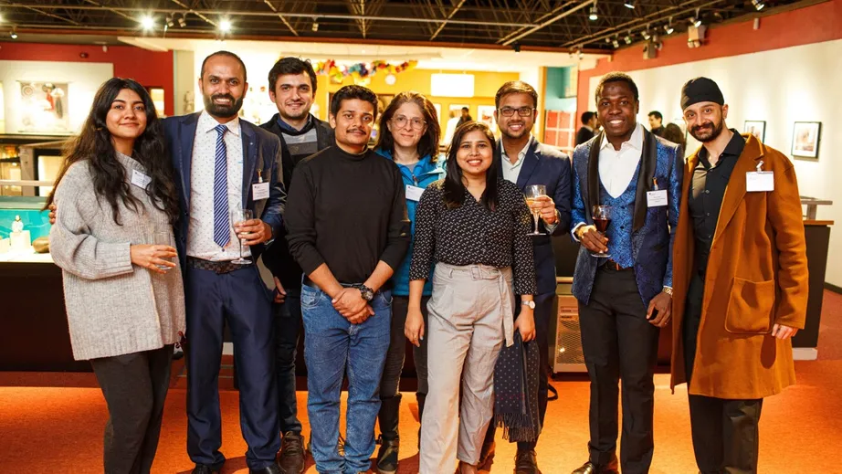 A group of guests posing for a photo at the International Scholars' Reception