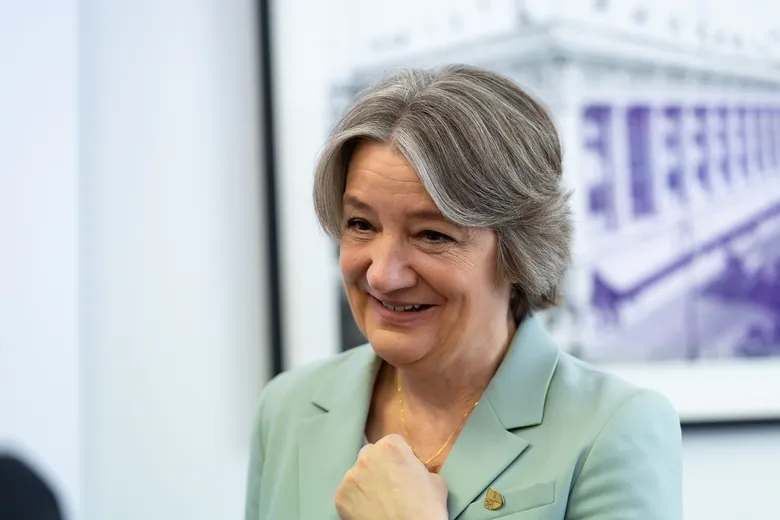 Woman smiling, looking to left of camera