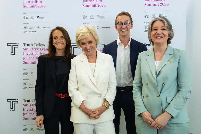 Four people smiling at camera