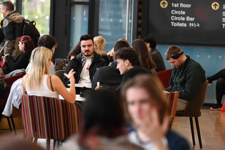 People sitting at tables in a cafe