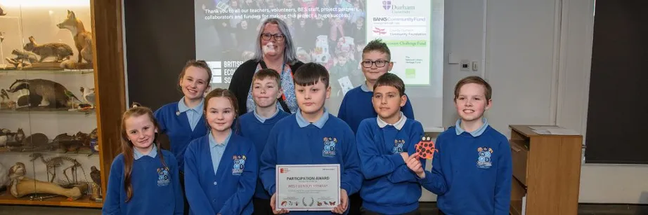 Schoolchildren collect a certificate