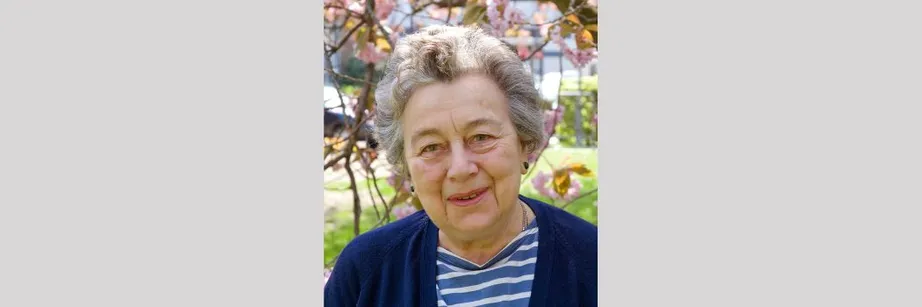 A portrait of Professor Dame Rosemary Cramp standing in front of a tree on a sunny day