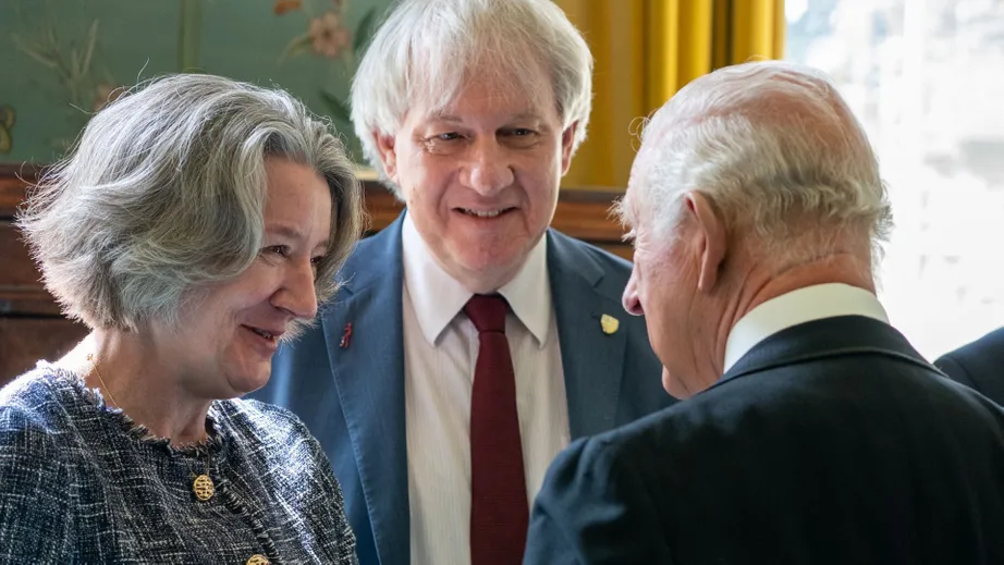 three people talking, smiling