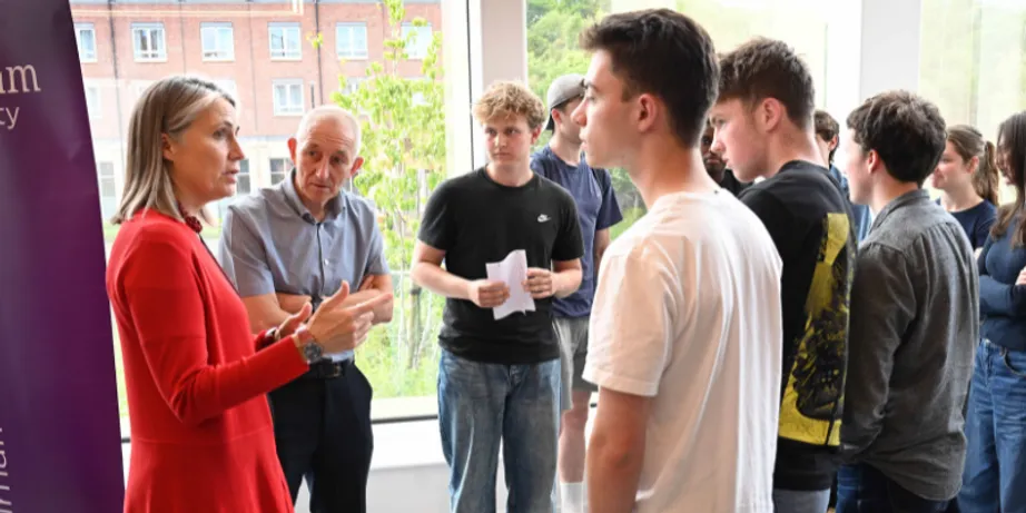 Chancellor Dr Fiona Hill talking to Gosforth Academy students and teacher Keith Wood